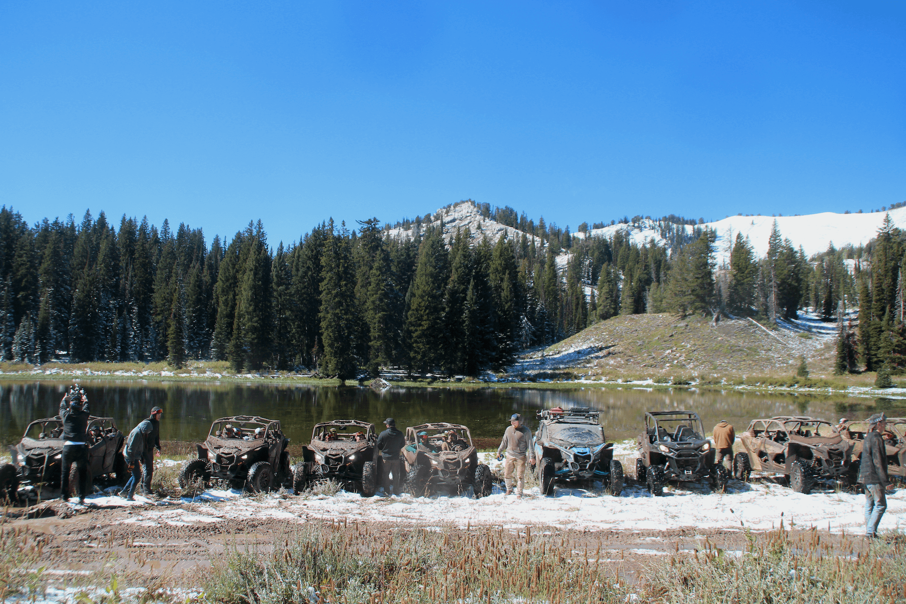 Group of people with parked UTVs at Tony's Grove